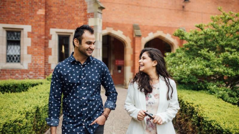 two students walking and chatting